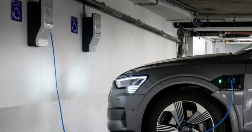Voiture électrique se rechargeant à une borne de recharge dans un parking souterrain